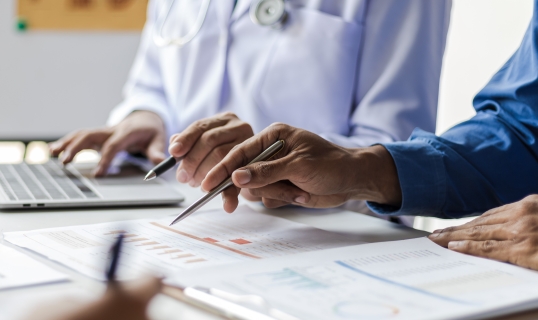 two people reviewing data charts