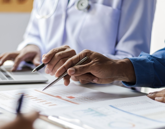 two people reviewing data charts