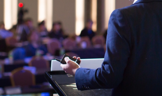 man presenting in front of audience