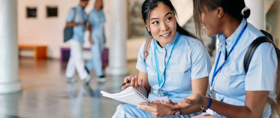 Two medical students talking to each other. 